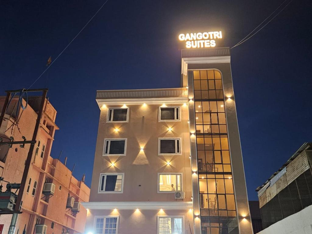 a building with a sign on top of it at Hotel Gangotri Suites in Haridwār