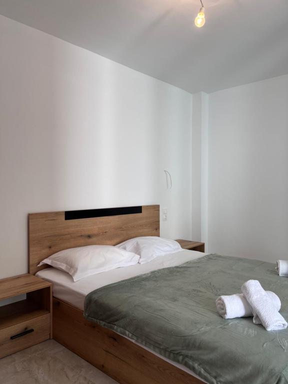 a bedroom with a large bed with two towels on it at Georges House in Nea Moudania