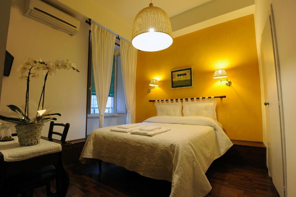 a bedroom with a bed and a table and a lamp at Federici Guest House in Rome