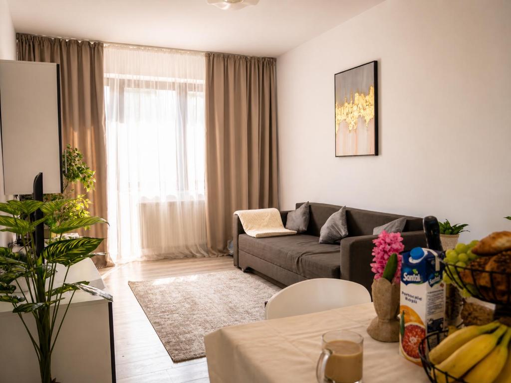 a living room with a couch and a table at Nolia Apartments in Bucharest
