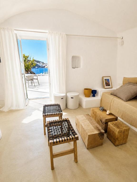 a white bedroom with a bed and a balcony at Maridea - Villa Zagara in Ponza
