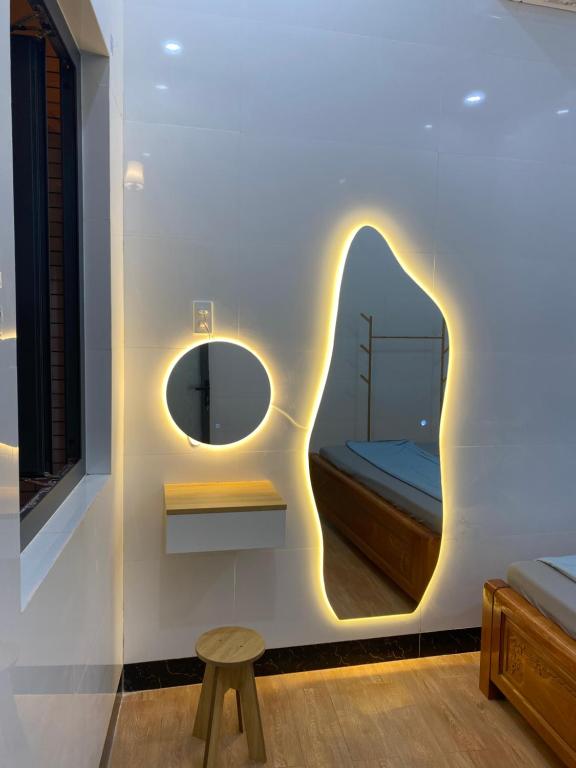 a room with a mirror and a bench and a bed at CoCo SEA in Mui Ne