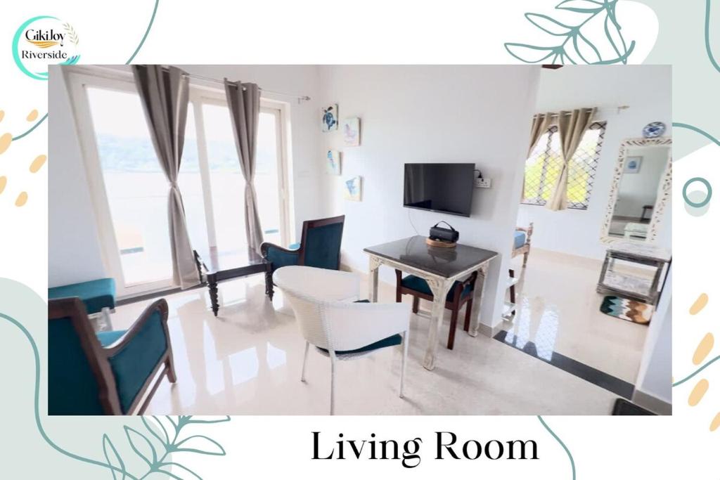 a living room with a table and chairs and a tv at Riverfront By Gikijoy in Agarvado