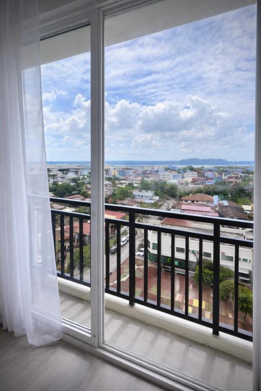 a balcony with a view of a city at Ocean View Studio Iloilo in Iloilo City