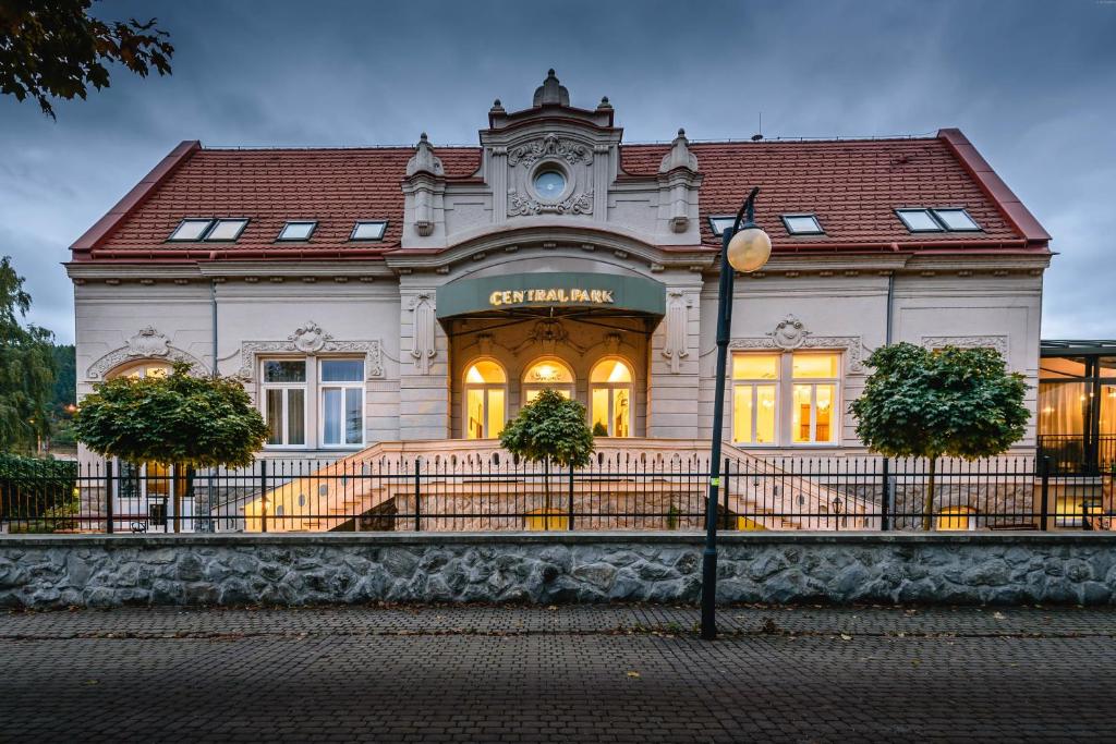 a building with a clock on the front of it at Penzión Central Park in Žilina