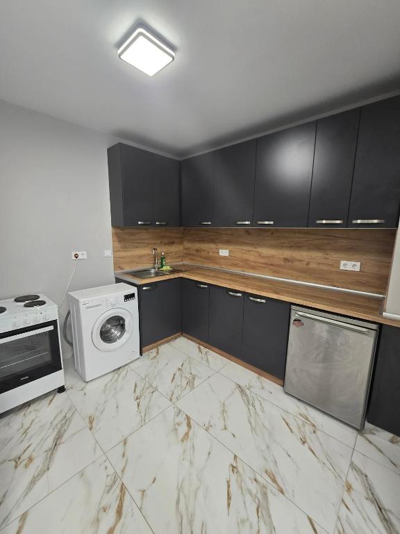 a kitchen with a washer and dryer at Icon Residence in Sofia
