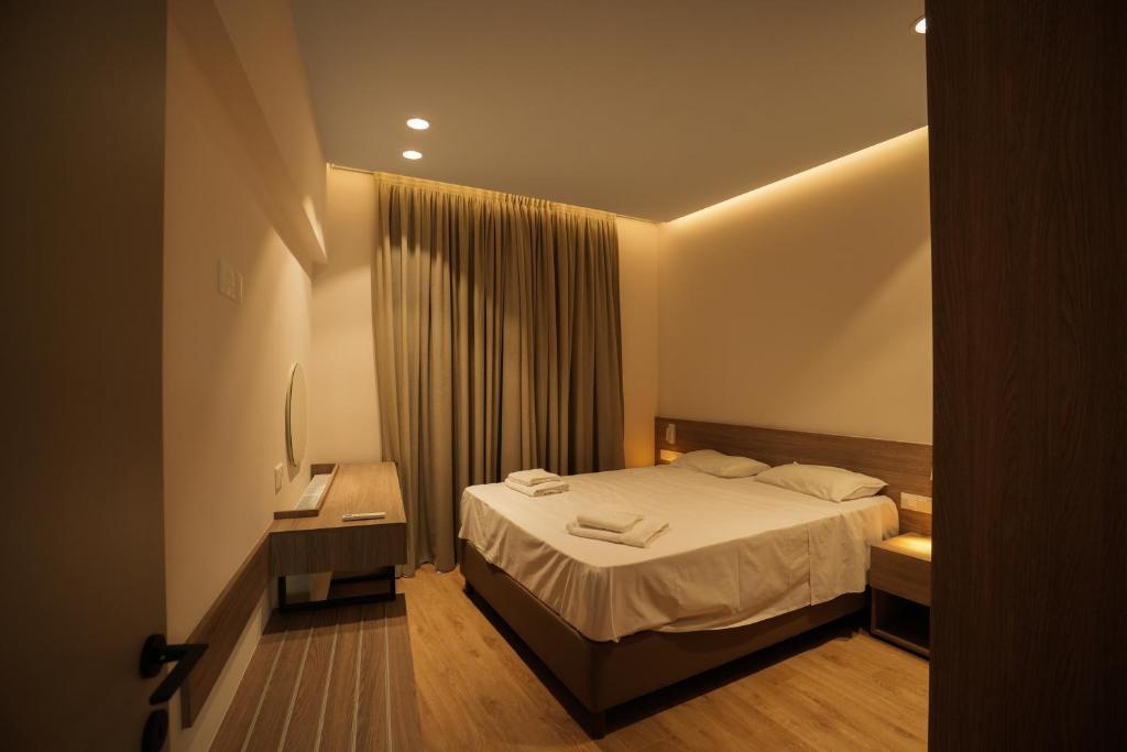 a hotel room with a bed and a television at Pissouriana hotel Apartments in Pissouri