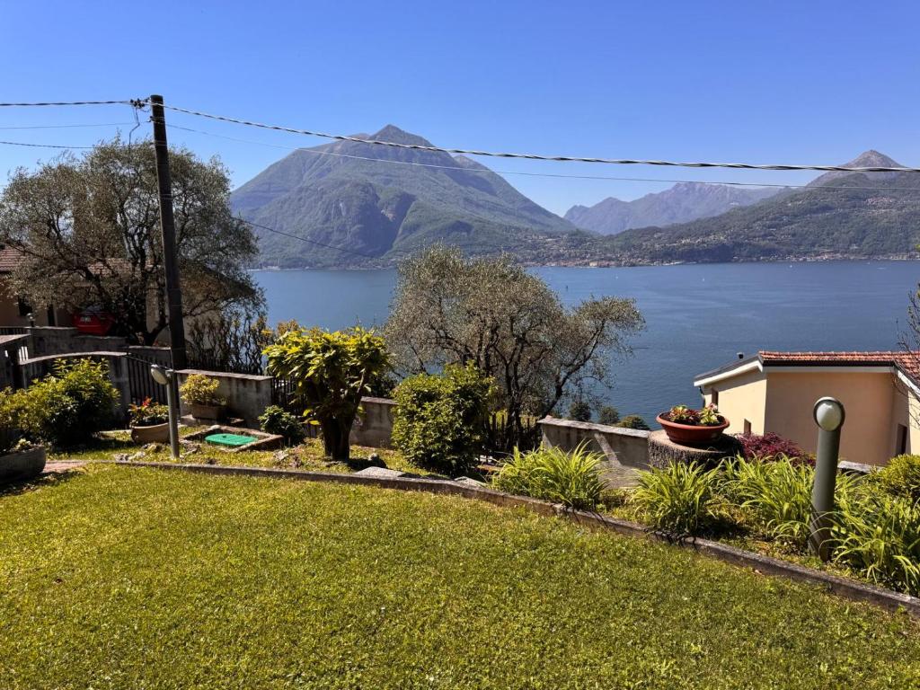 a house with a view of the water and mountains at Villa Bianca in Perledo