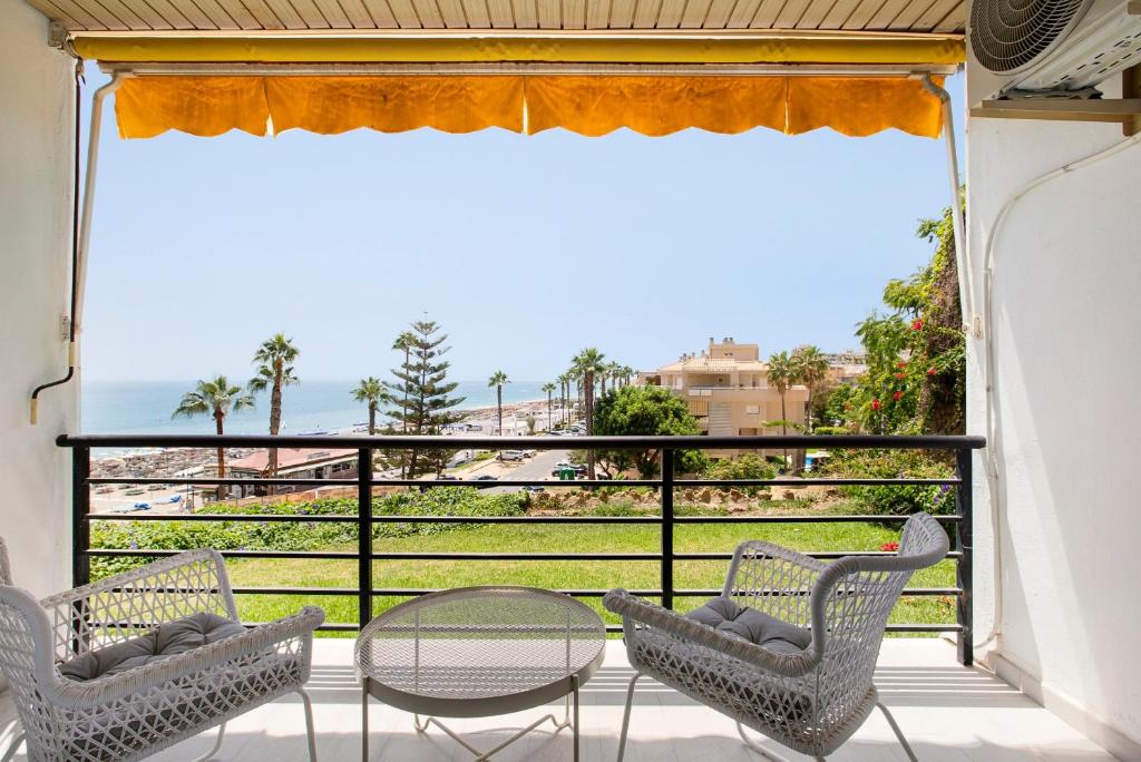 a balcony with chairs and a table and a view of the ocean at Casa Pedro Santa Clara in Torremolinos