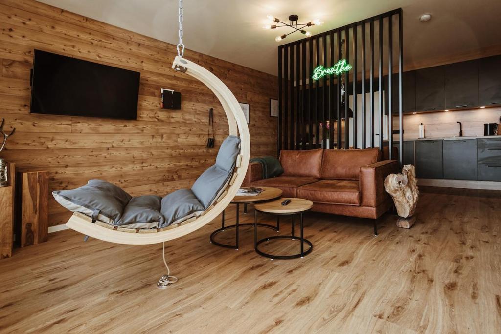 a living room with a chair and a couch at Harzchalet Emma 4 Sankt Andreasberg in Sankt Andreasberg