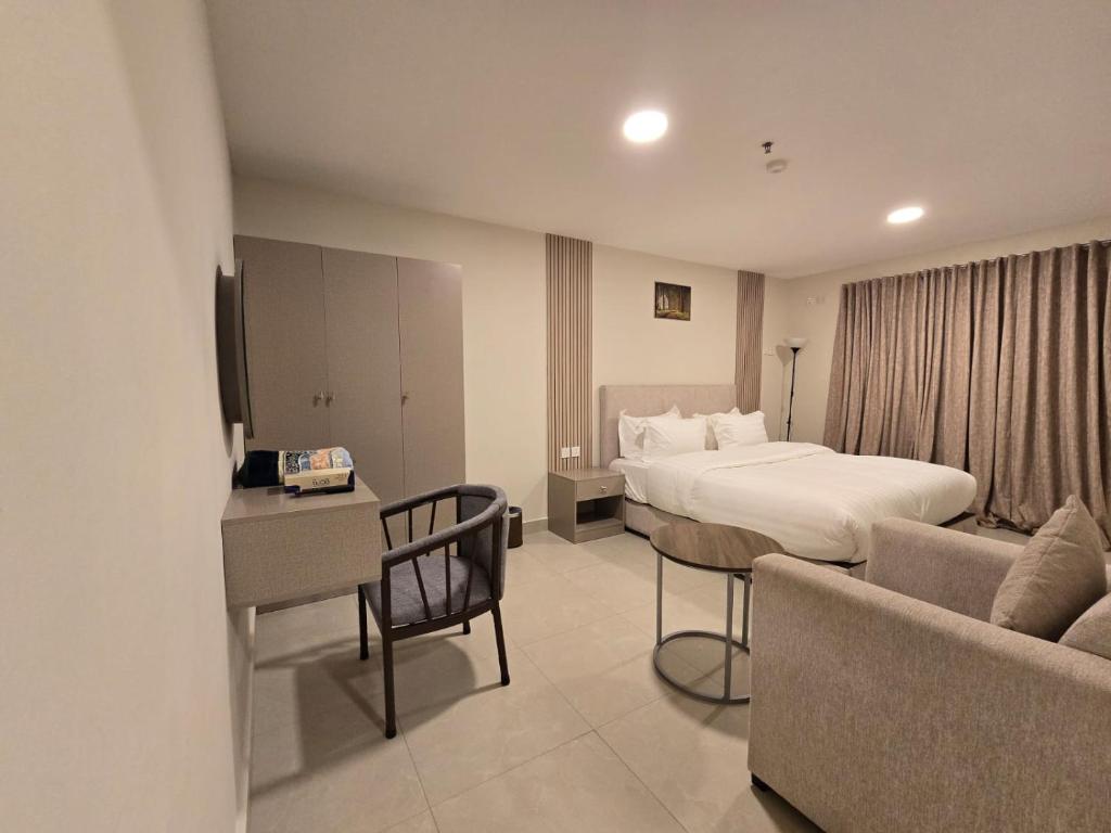 a hotel room with a bed and a couch at استديو سفاري الخبر in Al Khobar