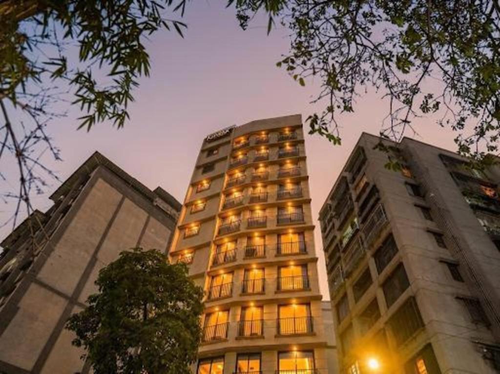 a tall building with its lights on at RaRa Residence in Mumbai