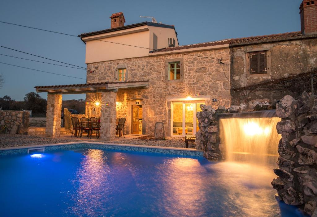 a villa with a swimming pool in front of a building at Villa Garica in Garica