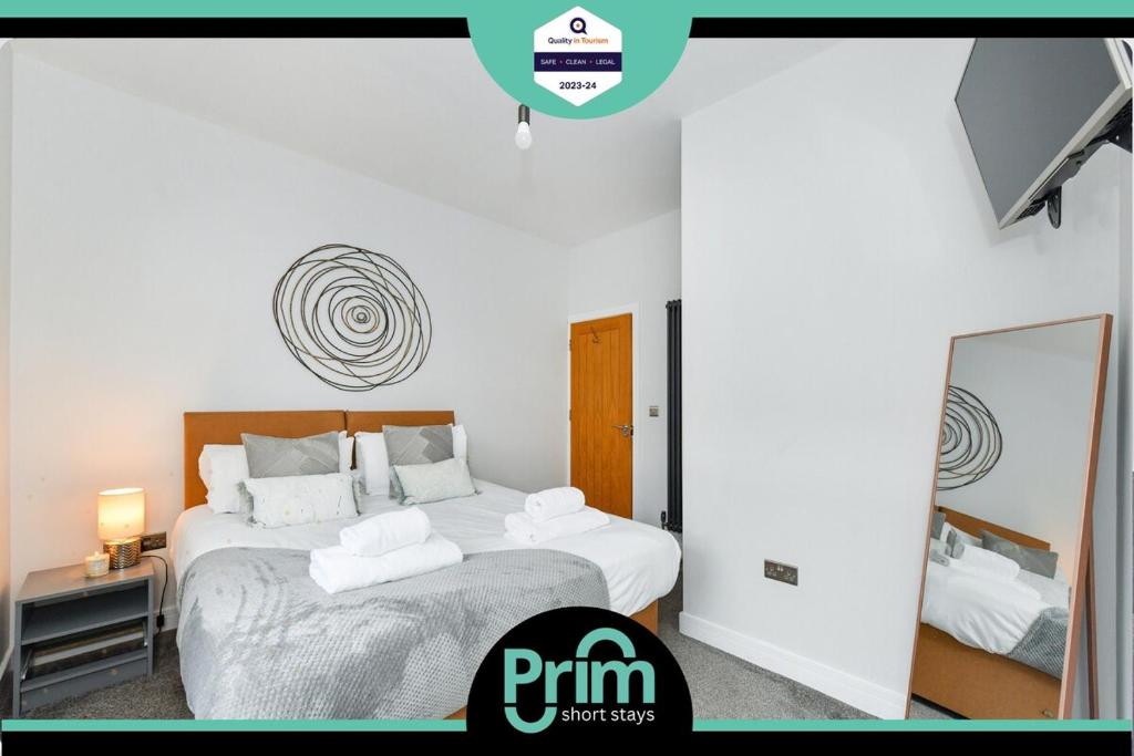 a bedroom with two beds and a mirror at Long Eaton Modern 4bed House in Long Eaton