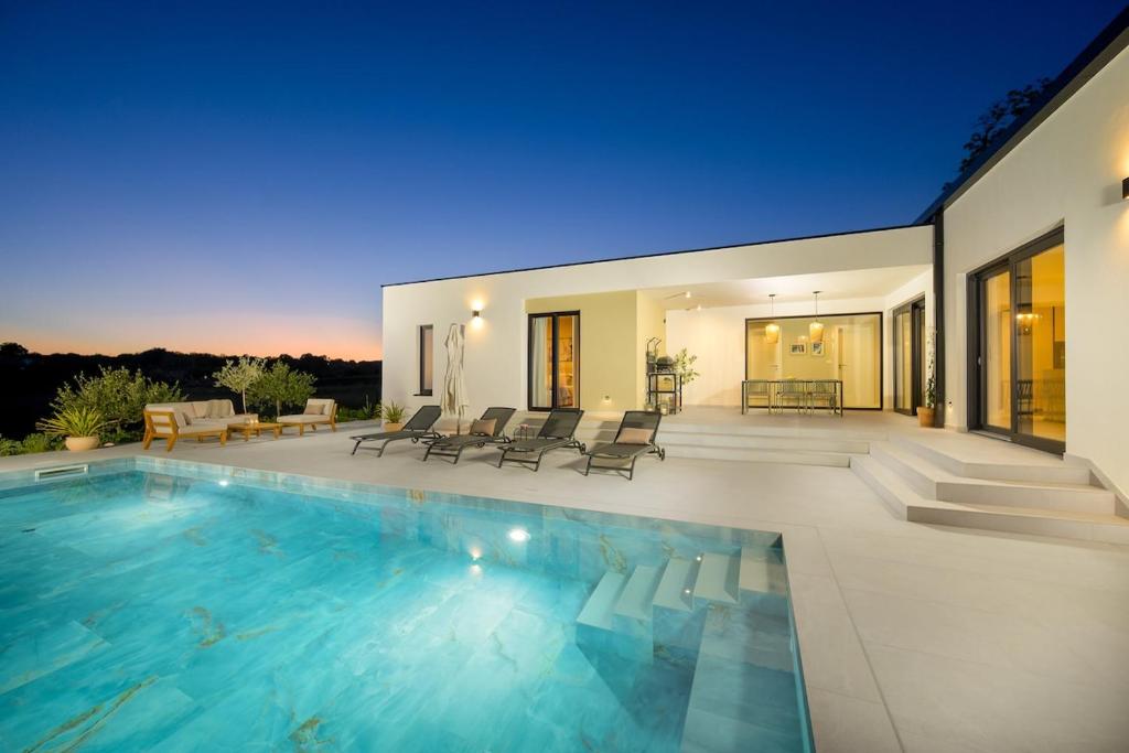 a swimming pool in the middle of a house at Villa Modrić by IstriaLux in Trviž