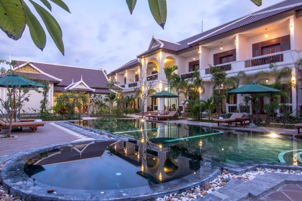 an exterior view of a resort with a swimming pool at De Arya Angkor Resort in Siem Reap