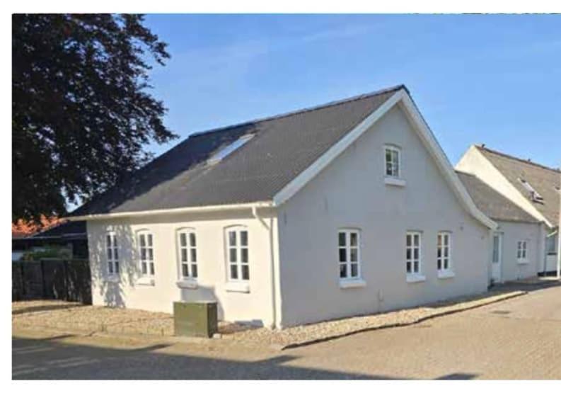 a white house with a black roof at 13min boxen, Legoland43min, MCH10min in Herning