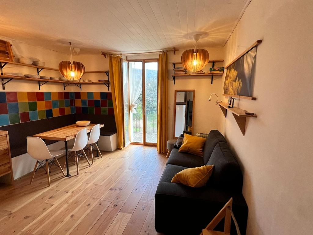 a living room with a couch and a table at Charming apartment in Nyons in Nyons