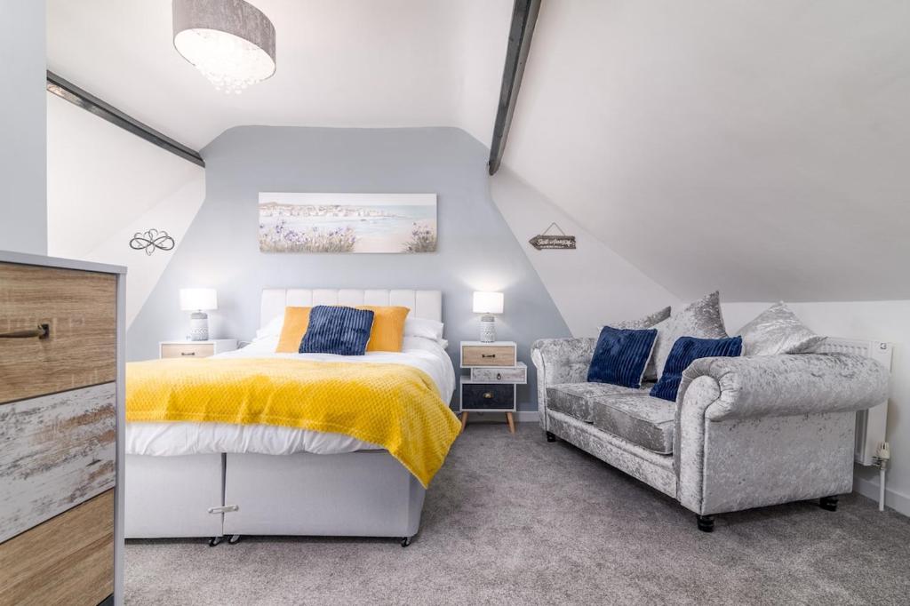 a bedroom with a bed and a chair at Hope Street in Filey