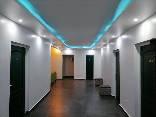 a hallway with a blue light on the ceiling at Narjis in Dzaoudzi