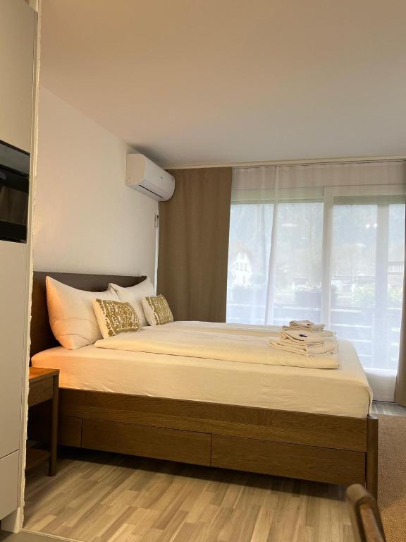 a bedroom with a large bed with a window at Rawda Ferien Wohnung 2 in Interlaken