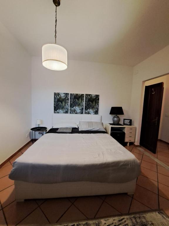 a bedroom with a large white bed in a room at GR room 22 in Sennori