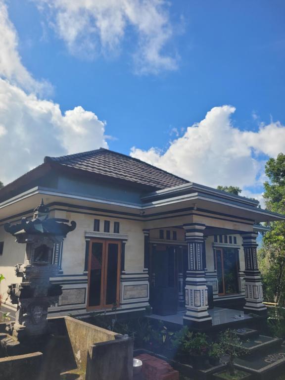 a small blue and white house with a sky at The Sinta Bali in Munduk