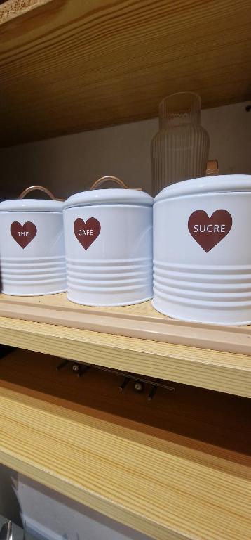 a shelf with three white bowls on a shelf at Urban Duo Saumur in Saumur