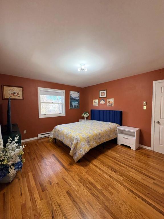a bedroom with a bed and a wooden floor at Downtown Halifax near waterfront in Halifax