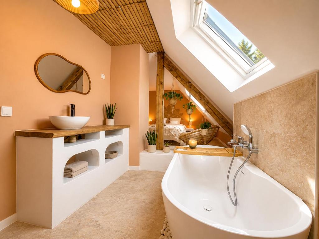 a bathroom with a large tub and a sink at Voyage à Bali in Sarreguemines