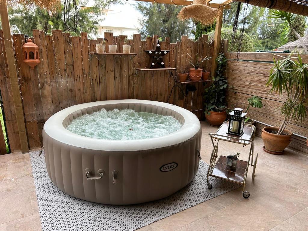 a hot tub in a backyard with a wooden fence at Ónice de Riviera 2 in Mijas Costa