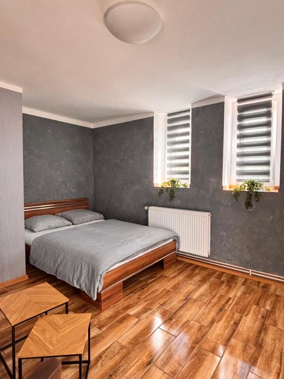 a bedroom with a bed and two windows at Northern Panorama in Jílové