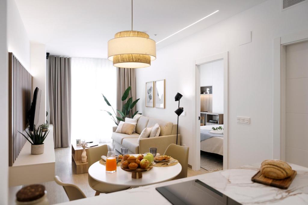 a living room with a couch and a table with fruit on it at REM III Premium Torrevieja in Torrevieja