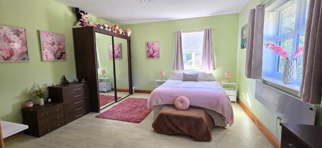 a bedroom with a bed and a large window at Boyne Place in East Hoathly