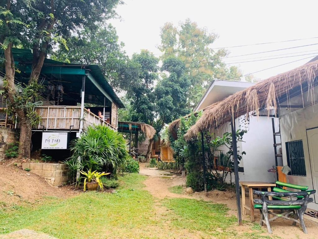 a house with a table and a bench next to it at Pai yard on Hill in Pai