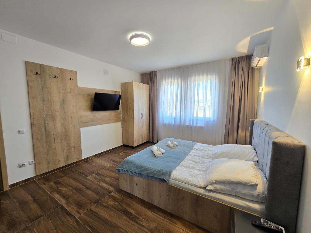 a bedroom with a bed and a tv in it at Hotel Arbëri Events in Rahovec