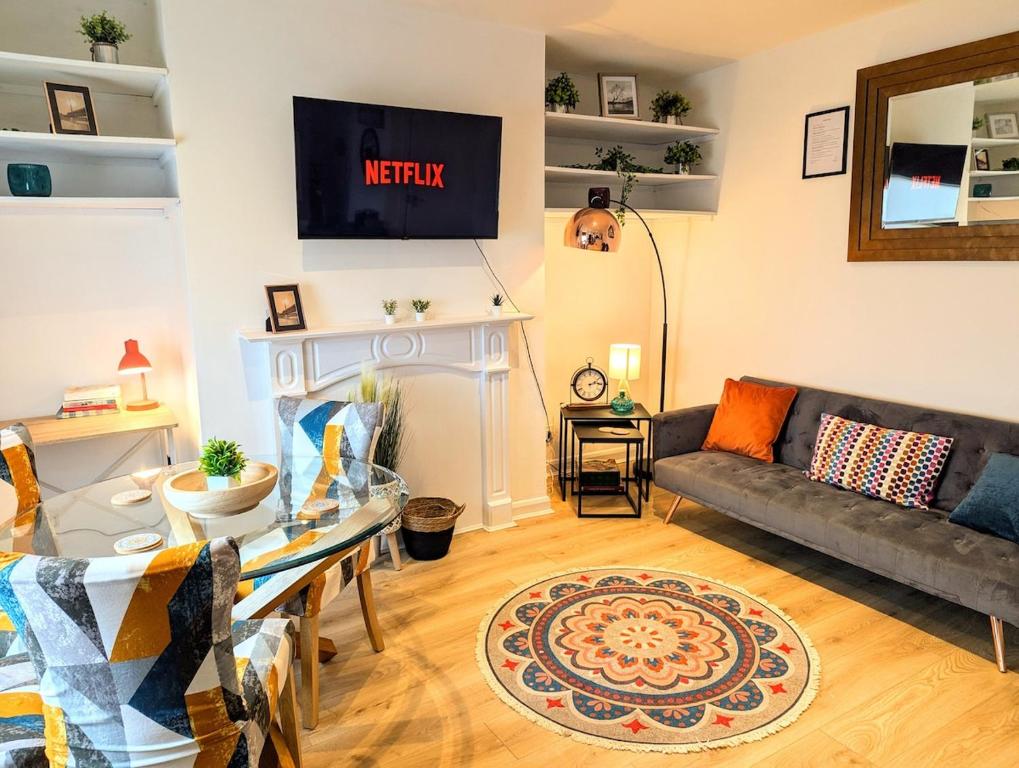 a living room with a couch and a fireplace at Stylish Townhouse - 8 Mins From Leeds - Free Fast WiFi - Free Parking in Headingley
