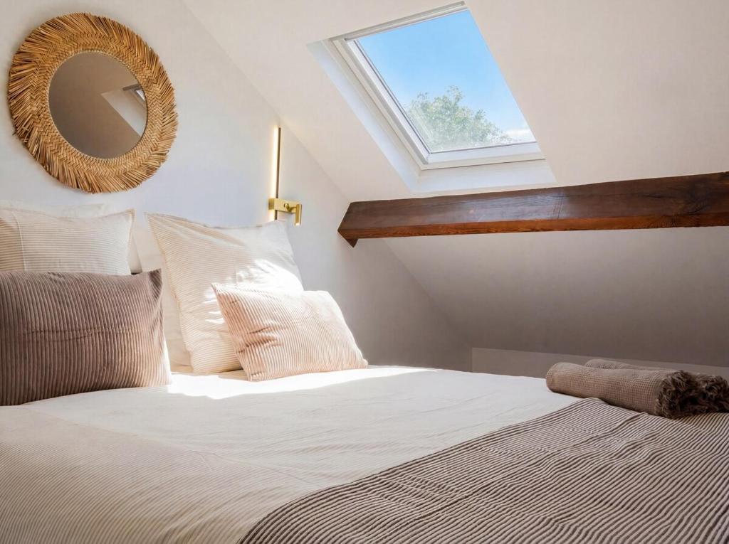 a bedroom with a bed with a mirror on the wall at Spacious Designer Duplex 9 Guests Fully Renovated in Châtillon