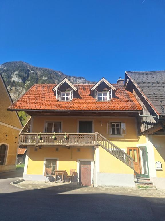 a house with an orange roof and a balcony at Schwarze Gräfin in Spital am Pyhrn