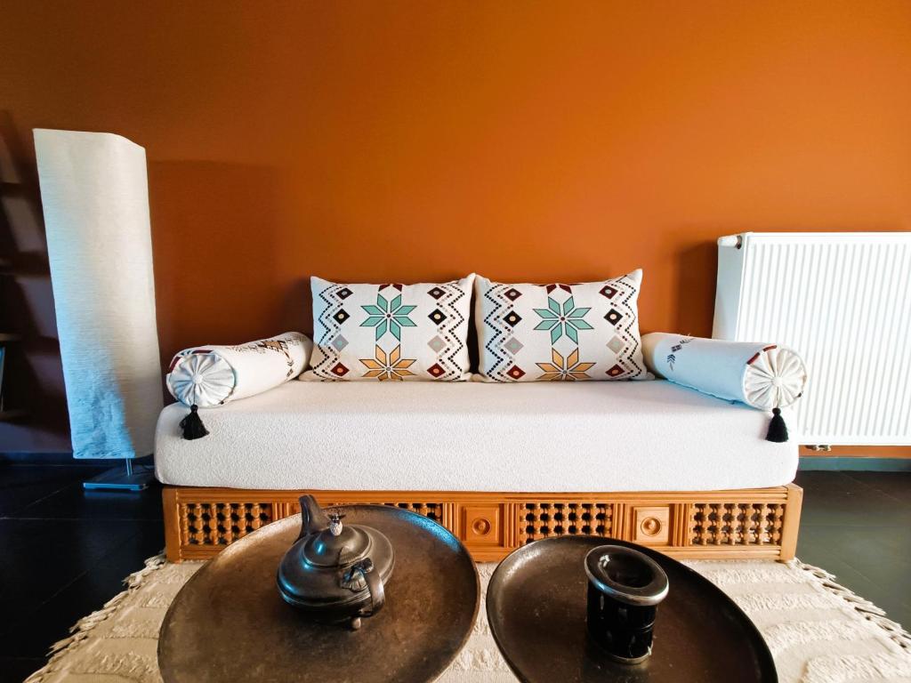 a small bed with two tables in a room at Aux 1001 Nuits Marrakech's touch in Chapelle-lez-Herlaimont