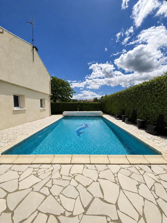 a swimming pool in the backyard of a house at Villa Patja in Béziers