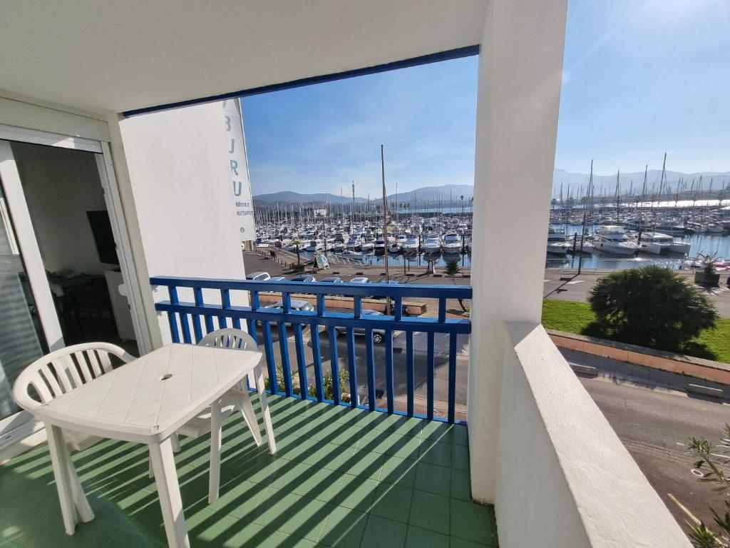 a balcony with a table and a view of a harbor at Sokoburu Deluxe Beach in Hendaye