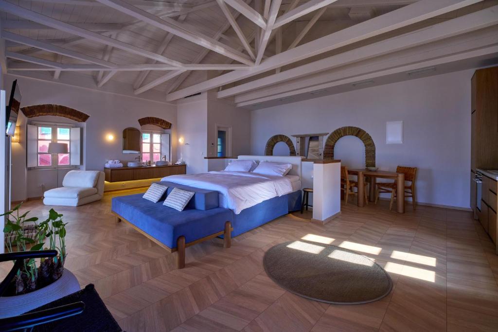 a large bedroom with a bed and a dining room at Casa Zacco in Parga