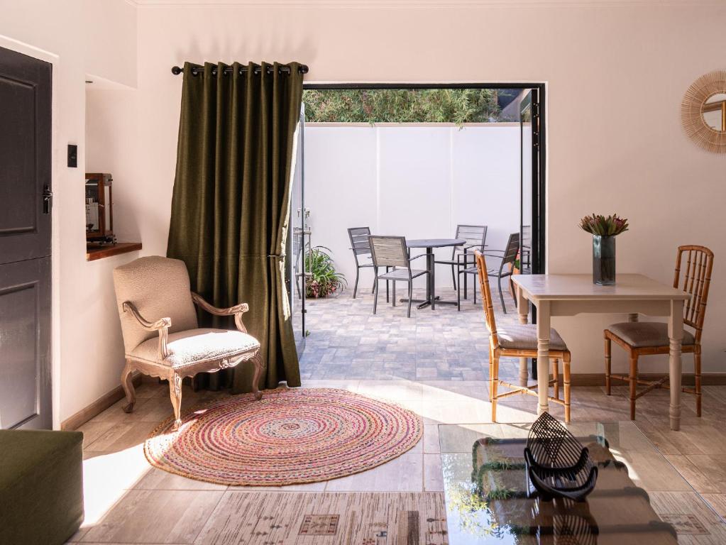 a living room with a table and chairs at Lombard Manor in Pretoria