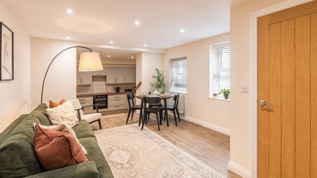 a living room and kitchen with a couch and a table at Newly Renovated 2-Bed Flat | Ripon Town Centre in Ripon