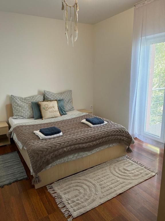 a bedroom with a bed with two pillows on it at Sentio Inn 2 in Dunajská Streda