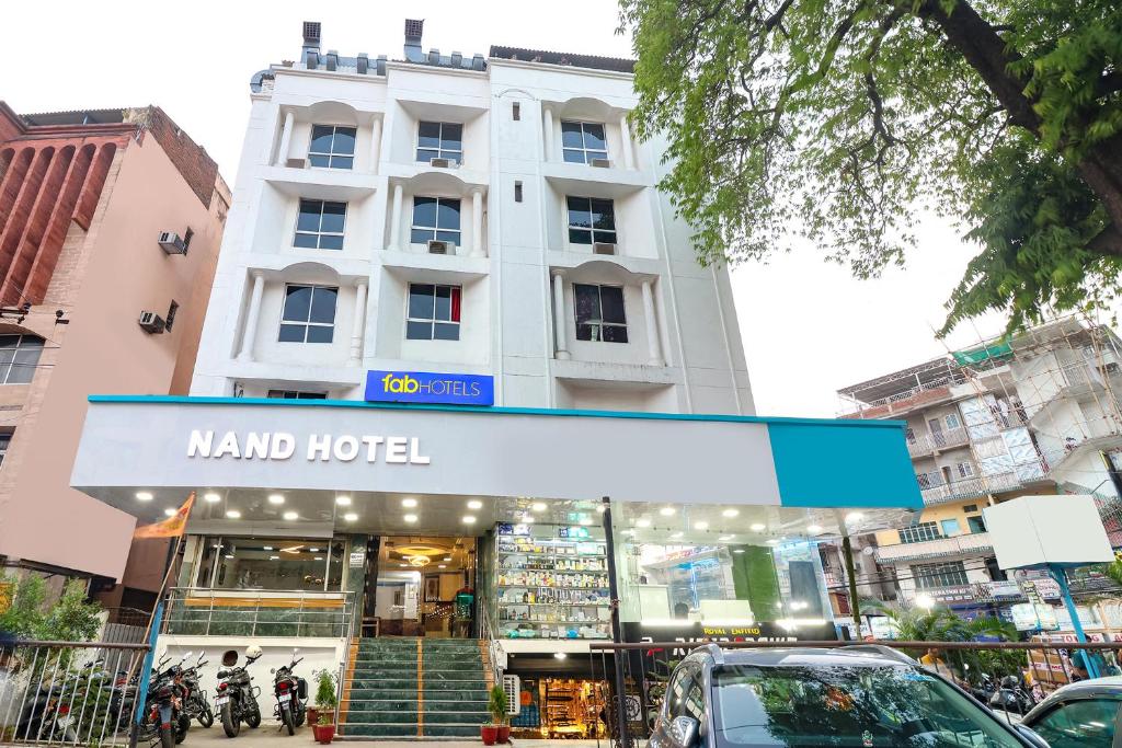 a building with a sign in front of a store at FabHotel Nand's Residency in Patna
