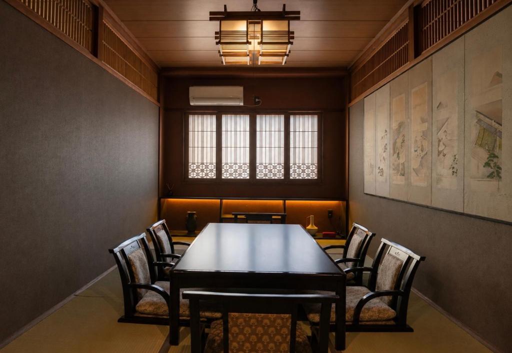 a dining room with a table and chairs at Konrai Hotel Matsumoto in Matsumoto