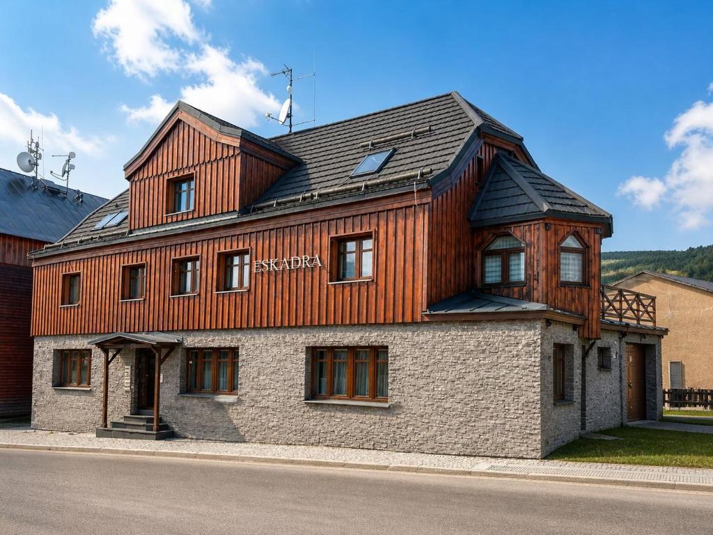 a house with a wooden roof on top of it at Apartmán Eskadra 1 in Horní Malá Úpa