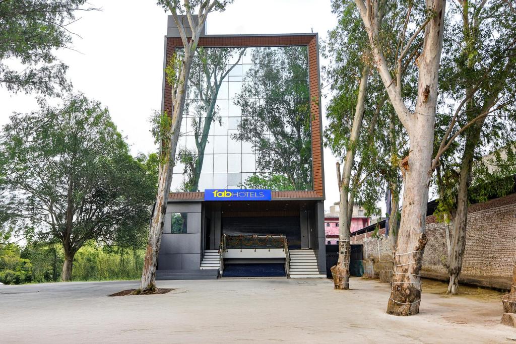 a building with a sign on the front of it at FabHotel Evegreen, Faridabaad in Faridabad